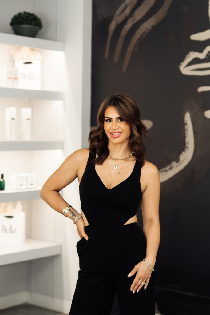 Portrait of salon manager Angela Myer posing in a black jumpsuit inside Bella Style Salon.